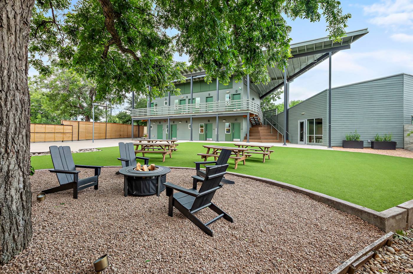 The Webber East courtyard with fire pit, Adirondack chairs, turf lawn and picnic tables