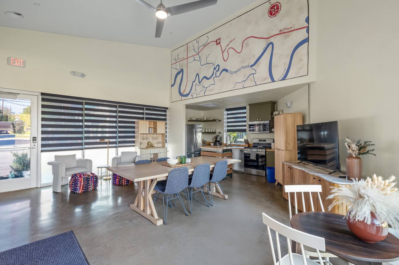 The Clubhouse dining area with tables and a large hand-drawn Austin map mural