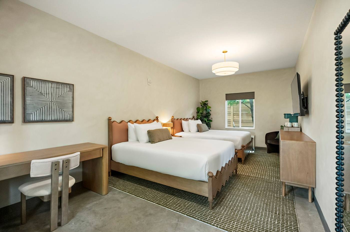 Guest room at Webber East with a queen bed and warm natural light